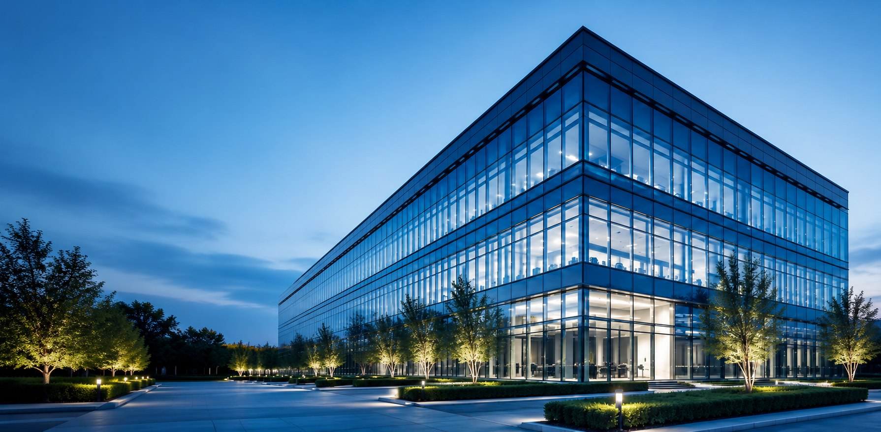 Modern corporate glass office building at dusk