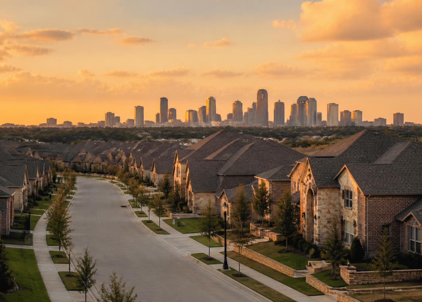 North Texas suburban street with newly built brick and stone homes and a distant skyline at sunset