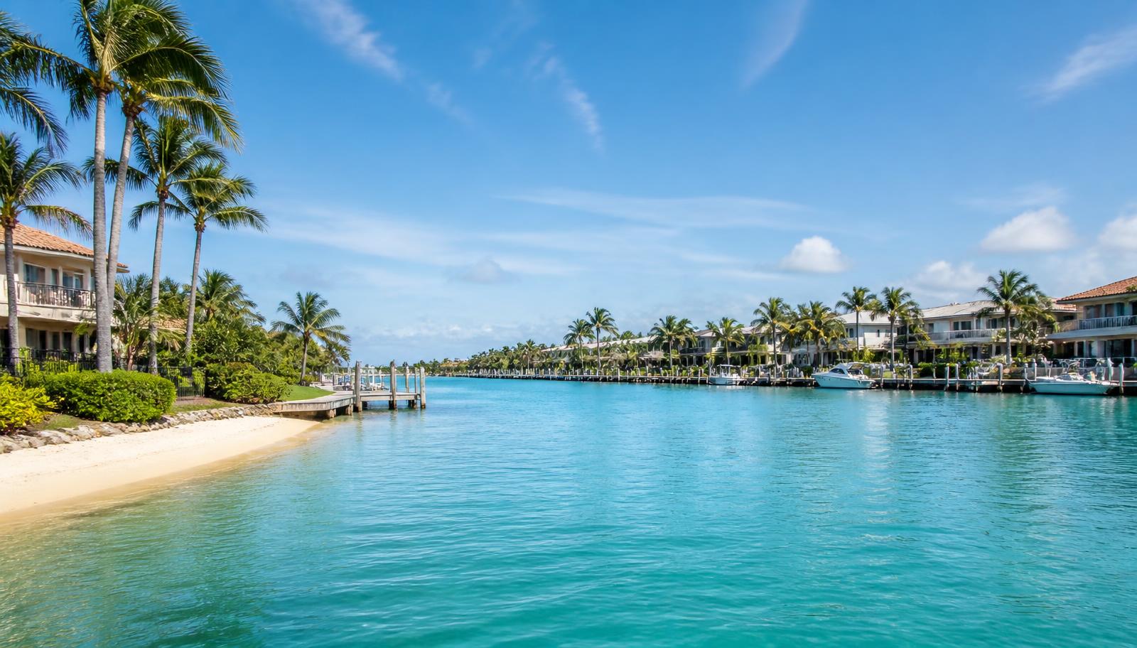 Florida waterfront homes along a calm turquoise waterway with palms